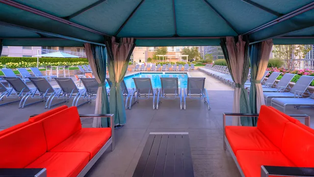 Grand Plaza club floor — pool deck with loungers and city towers, the 9th-floor amenity level at 545 N Dearborn, Chicago