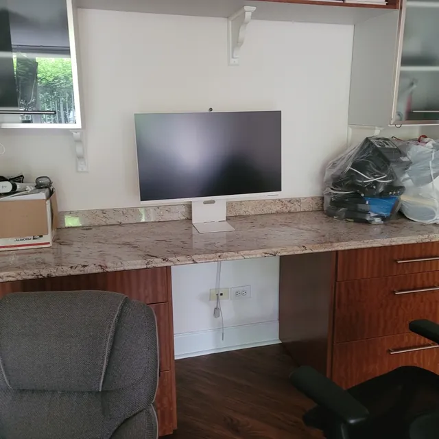 Unit W907 — the den and flex office, with its built-in granite-top desk, drawers, and shelving